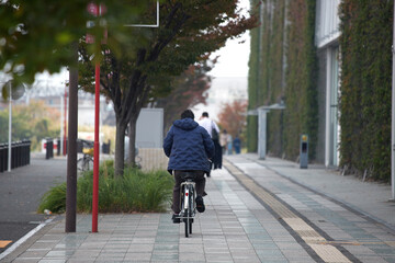 秋の沼津の街で歩く人々と自転車の乗る人の姿