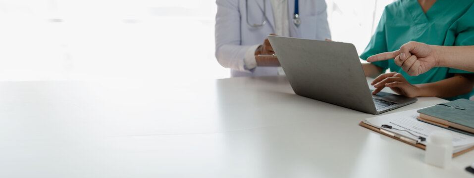 A group of doctors meets together to solve the problem of the epidemic, There was a meeting about major surgery in the hospital, The doctor takes the patient's documents and discusses them with team.