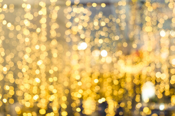 Blurred of Christmas light bokeh for backdrop design , Abstract blur gold bokeh background
