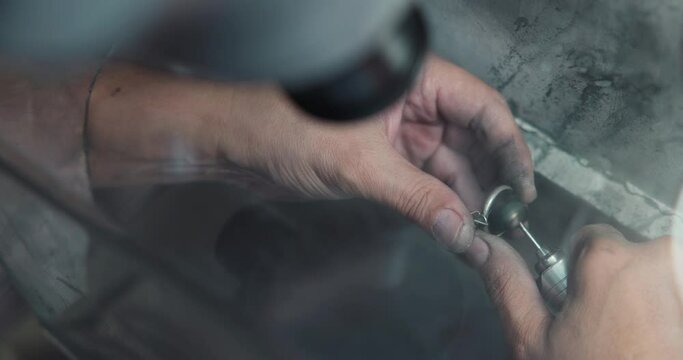 jeweler polishes a ring during the making process in a workshop