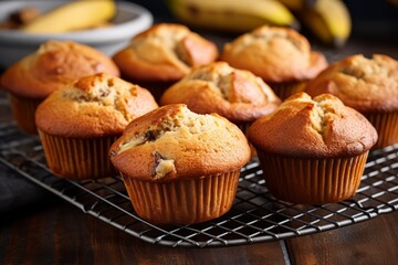 Freshly baked banana muffins on a cooling rack - Powered by Adobe