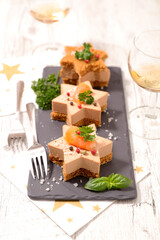 festive luxury canape with foie gras, wine glasses on christmas celebration table