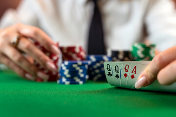 woman in a classic white shirt and tie at the poker table starts the game.