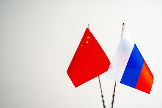 Russian and Chinese flags on negotiation table