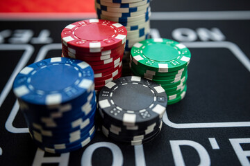 poker chips stack  on a black casino table. Poker game theme, gambling concept