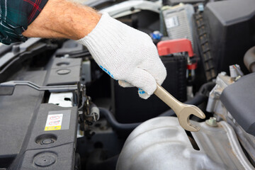 the driver inspects the engine compartment of the car.