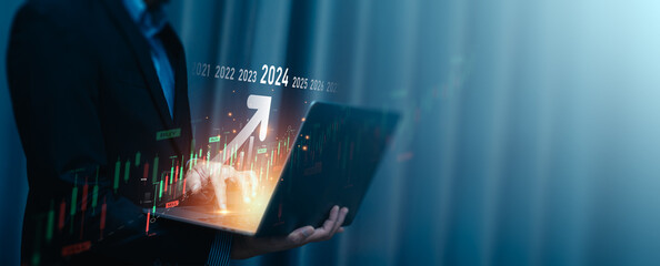 Obraz premium Explore the stock market trends for 2024, analytical businessman planning business growth 2024, strategy digital marketing, profit income, economy, stock market trends and business, technical strategy