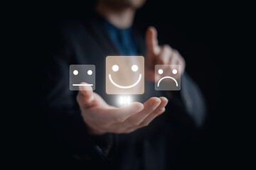 customer service evaluation and feedback rating. costumer review concept, man using phone chooses happy smiling face