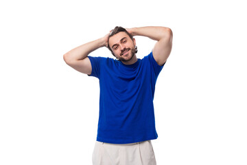 Fototapeta premium young smart handsome european man with black hair and beard dressed casually against the background with copy space