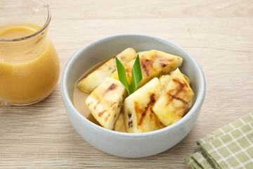 Pisang Gapit or Pisang Epe, grilled banana with palm sugar sauce. Indonesian traditional food.
