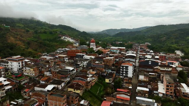 Aerial view approaching the St Raphael's Church in cloudy Antioquia, Colombia
