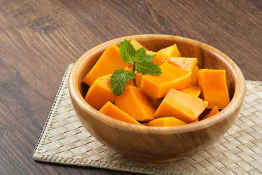 Fresh and ripe mango fruit slice on wooden bowl
