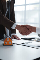 House developers and customer shaking hand after accept agreement finish buying or rental real...
