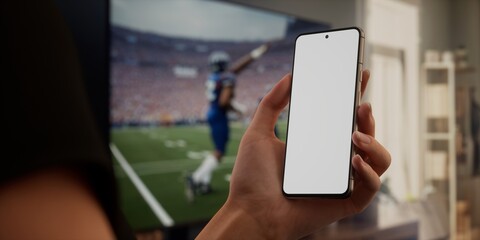 Caucasian woman watching football at home with friends, making bets on his phone