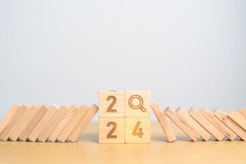 2024 year and falling blocks with magnifying glass icon. SEO, Search Engine Optimization, hiring ,...