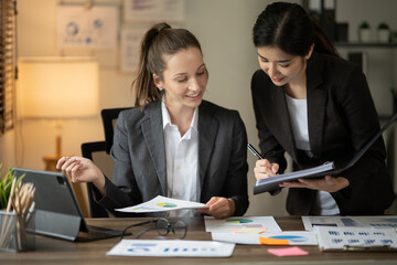 Asian businesswomen and talk about new projects, presents at home office.