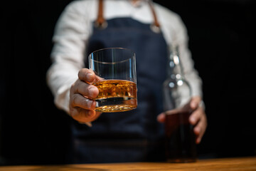Fototapeta na wymiar Barman pouring whiskey whiskey glass..