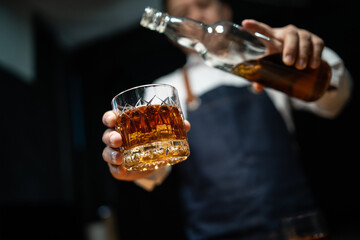 Barman pouring whiskey whiskey glass beautiful night
