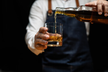 Barman pouring whiskey whiskey glass beautiful night