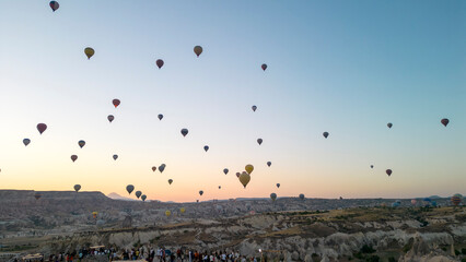 Hot air balloons. Hot air balloons flying over Fairy chimneys in Cappadocia at sunrise. Aerial...