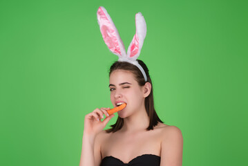 Portrait of a cheerful pretty young girl celebrating easter isolated over studio background. Studio...