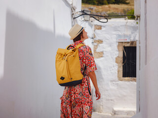 Nice asian Female in boho dress Enjoying Sunny Day on Greek Islands. Travel to Lindos,...
