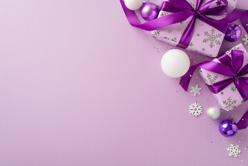 Convey your best wishes with this delightful gift arrangement. Top view of beautiful presents, celebratory balls, sparkling sequins, snowflakes on purple backdrop, designed for your personal message