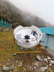 Warming the teapot in a solar cooker. Nepal. Himalaya