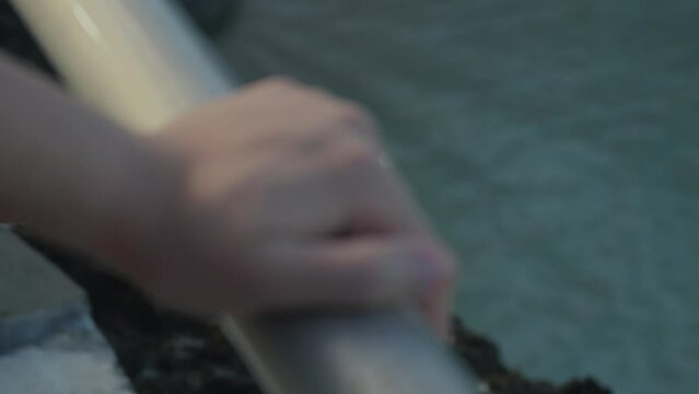 Close up shot of a hand holding the railing at the beach