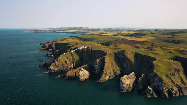 Aerial Shot Of St Abbs Head And Lighthouse On Scottish Coast Near Edinburgh, Scotland, United Kingdom