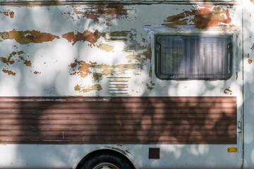 A heavily used caravan with windows and curtains - obrazy, fototapety, plakaty
