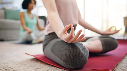 Fotobehang Yoga, meditation and lotus, hands of women in home to relax and mindfulness training in living room. Balance, calm and workout, friends in holistic exercise for peace and zen mind health in apartment © Azeemud/peopleimages.com