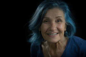 Modern Elderly Woman with Blue Eyes and Blue Hair Smiling - 673673100