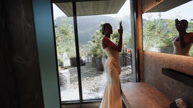 Stylish dark-skinned bride posing in a white dress at a wedding photo shoot. Wedding concept