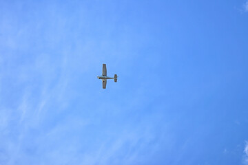 A small plane in a blue sky 
