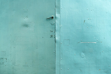 Old handle on worn metallic gate