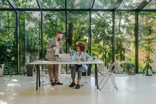 Happy design professionals having discussion in office