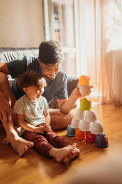 Father and son playing leisure games sitting at home
