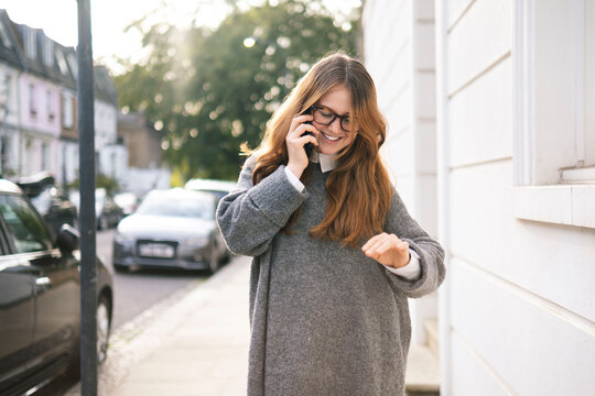 Young woman with long hair talking on smart phone