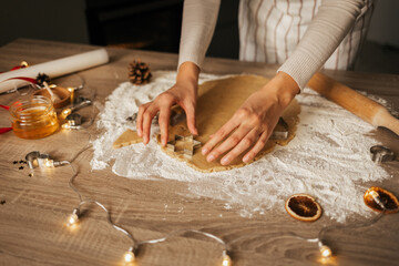 A close-up of the process of making New Year's gingerbread cookies in an atmospheric kitchen at...