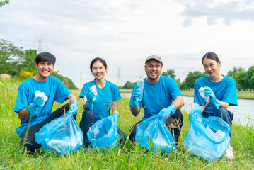 Volunteering, charity and clean environment concept. Happy asian diverse group of volunteers with...