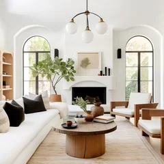 Foto op Canvas Rustic coffee table between sofa and chairs against fireplace and arched windows. Mediterranean modern cottage style home interior design of modern living room. © Vadim Andrushchenko
