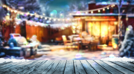 Obraz premium wooden table and winter party in backyard garden with grill BBQ, blurred background