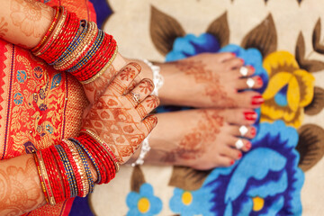 Indian Wedding Concept. Beautiful feet of an Indian bride, decorated with auspicious Mehndi,...