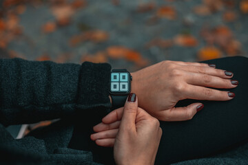 Woman looking at smartwatch on her hand