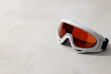 White ski goggles on a light background