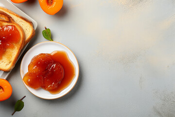Toast with homemade apricot jam on a plate on a beautiful background, top view.copy...