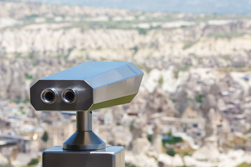 Tourist Big Binoculars in Cappadocia. Defocused landscape at background