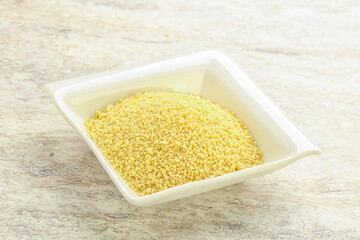Raw couscous in the bowl