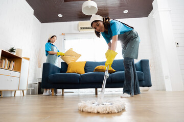 Professional housekeeper services company team working at customer house to clean up the floor,...